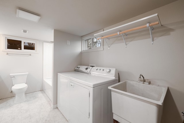 laundry area with washer and dryer and sink