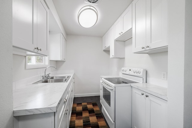 kitchen with white cabinets, electric range, and sink