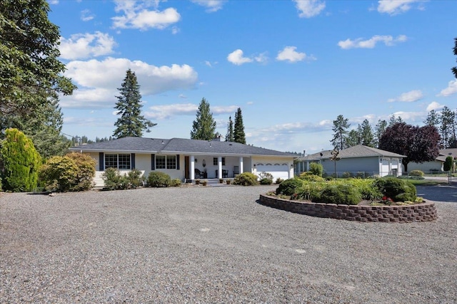 ranch-style house featuring a garage and driveway