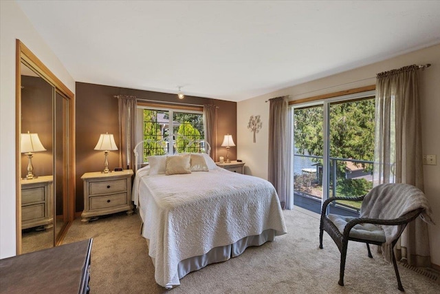 bedroom featuring access to exterior and light colored carpet