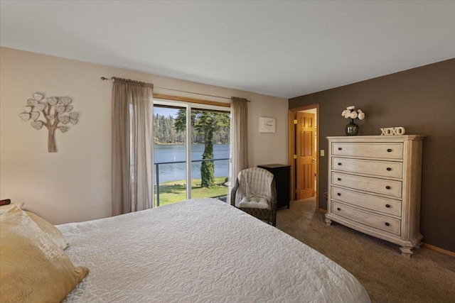 bedroom featuring access to exterior, dark colored carpet, a water view, and baseboards