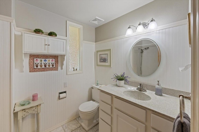 bathroom featuring visible vents, toilet, and vanity