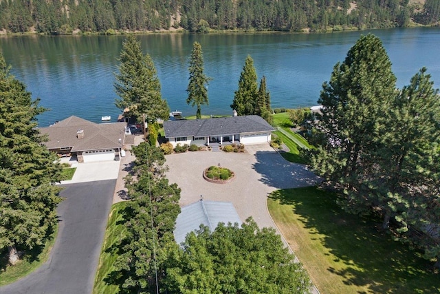 drone / aerial view with a water view and a wooded view