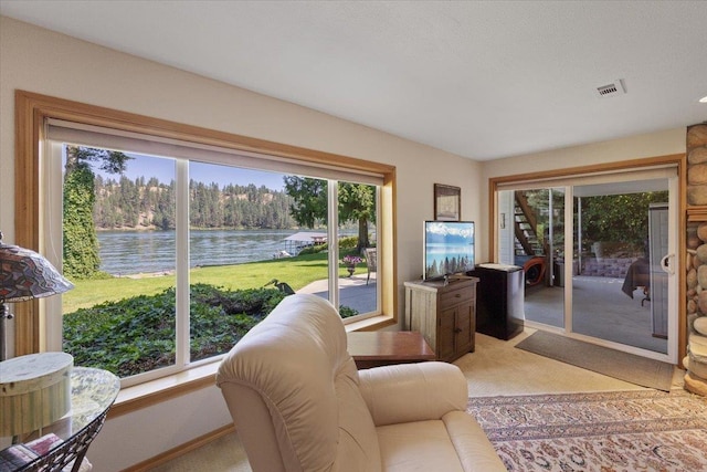 living area with light colored carpet and visible vents