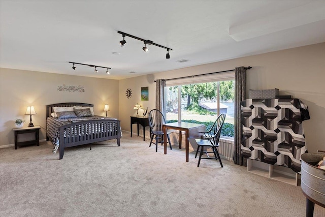 carpeted bedroom with visible vents and baseboards