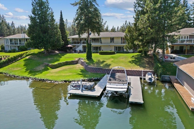 dock area with a lawn, a water view, and boat lift