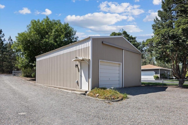 detached garage featuring fence