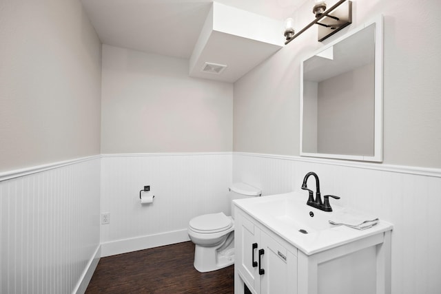 bathroom with vanity, hardwood / wood-style floors, and toilet