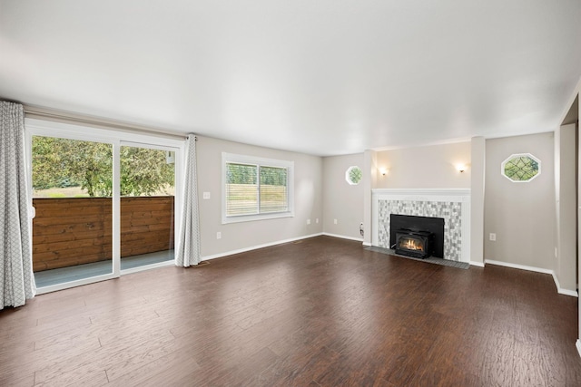 unfurnished living room with a tiled fireplace and hardwood / wood-style floors