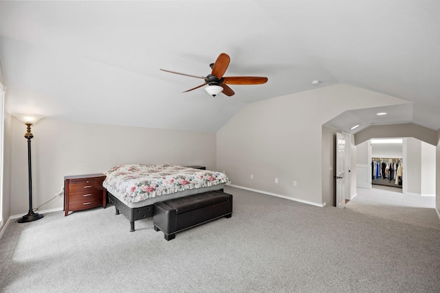 bedroom with ceiling fan, light colored carpet, and lofted ceiling