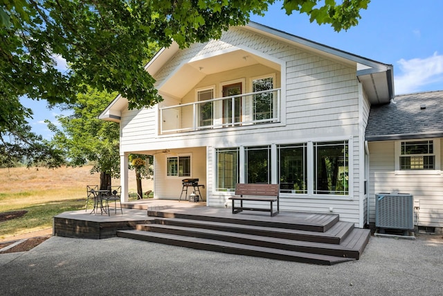 rear view of house with a patio and central AC