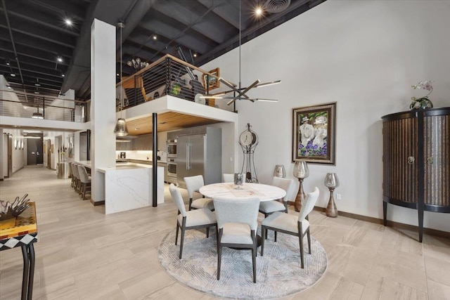 dining area featuring a high ceiling