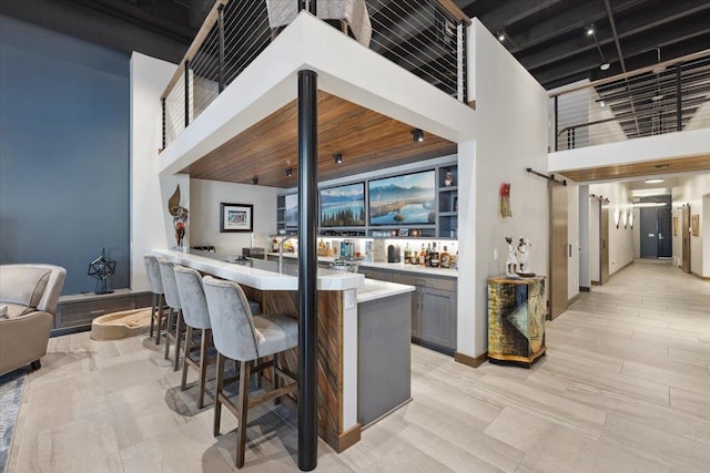 interior space with a high ceiling and gray cabinets