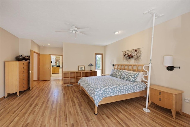 bedroom featuring light wood finished floors, a ceiling fan, and baseboards