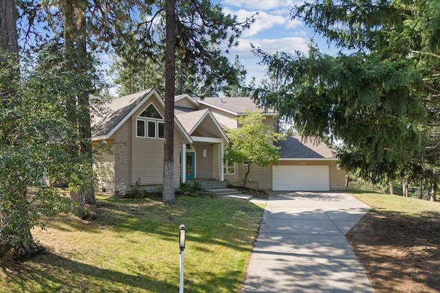 view of front facade with an attached garage, driveway, and a front lawn