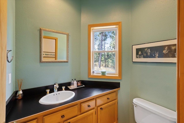 half bath featuring toilet and vanity