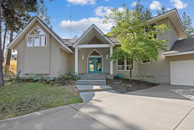 view of front of property with french doors and concrete driveway