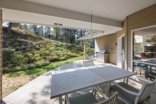 view of patio featuring grilling area and outdoor dining area