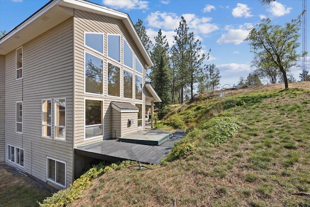 view of side of property featuring a wooden deck