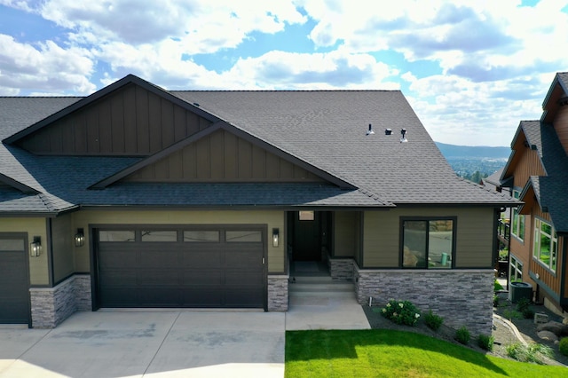 view of front of house featuring cooling unit and a garage