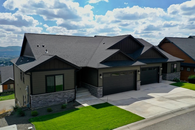 craftsman-style home with a front lawn and a garage