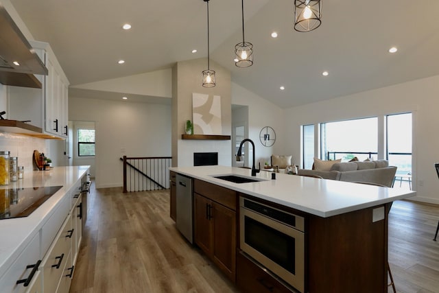 kitchen featuring light hardwood / wood-style floors, sink, stainless steel appliances, and white cabinets