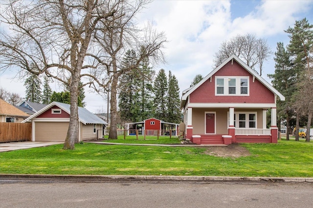 craftsman-style house with a garage, an outdoor structure, a porch, and a front yard