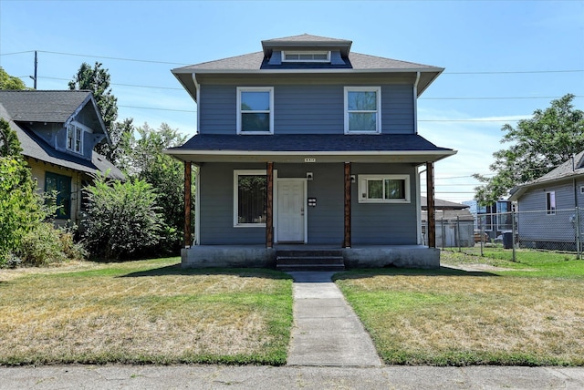 view of property featuring a front lawn and covered porch