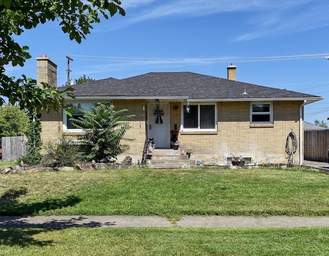 ranch-style home with a front lawn