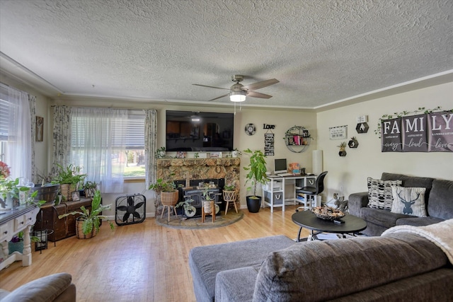 living room with hardwood / wood-style floors, ceiling fan, and a textured ceiling