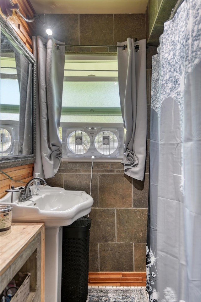 bathroom with tile walls