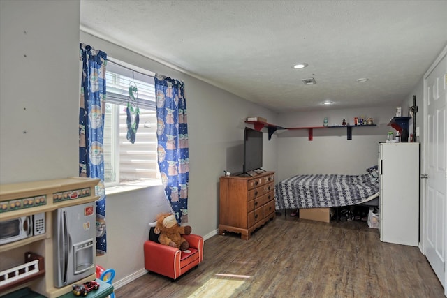 bedroom with dark wood-type flooring and a textured ceiling