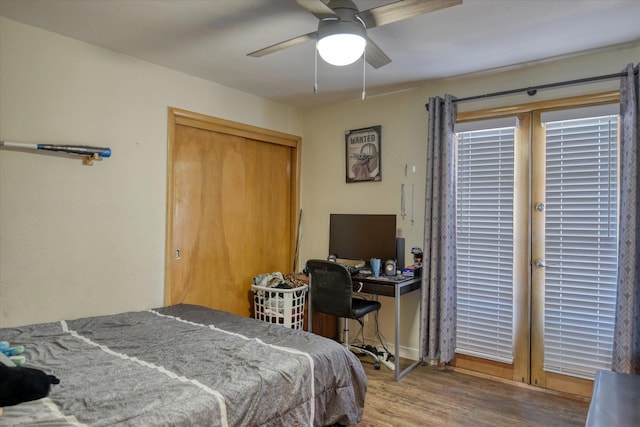 bedroom with a closet, ceiling fan, and wood-type flooring