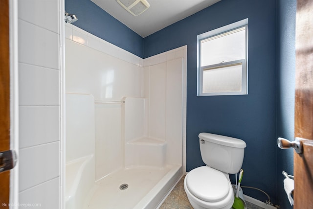 bathroom with tile patterned floors, toilet, and walk in shower