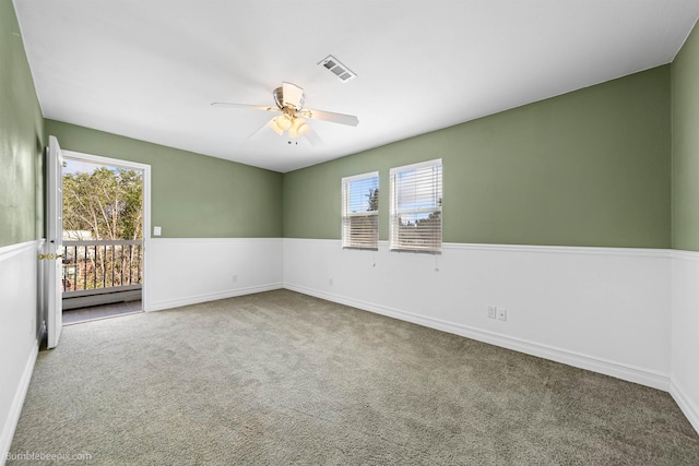 unfurnished room featuring carpet floors, ceiling fan, and a baseboard heating unit