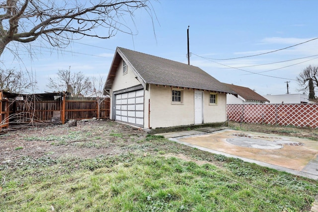 view of yard with a garage and an outbuilding