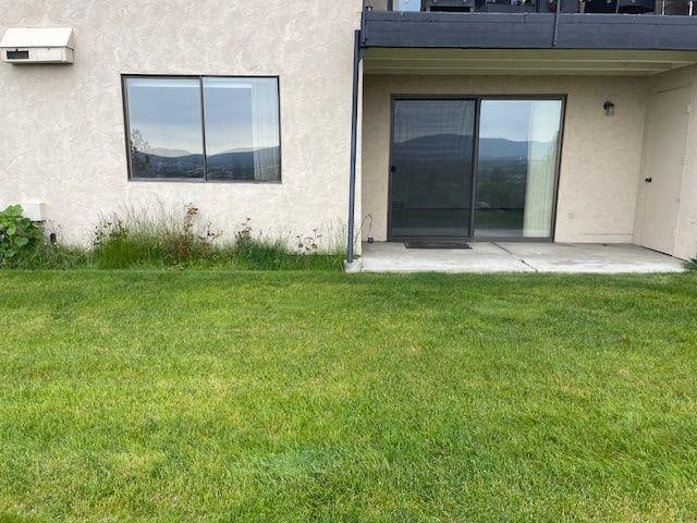 5307 N Argonne Ln # 6, Spokane, WA 99212 - view of exterior entry with stucco siding, a lawn, and a patio