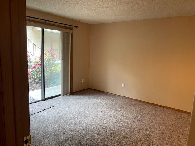 5307 N Argonne Ln # 6, Spokane, WA 99212 - unfurnished room with light colored carpet, a textured ceiling, and baseboards