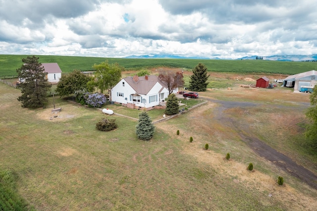 birds eye view of property with a mountain view and a rural view