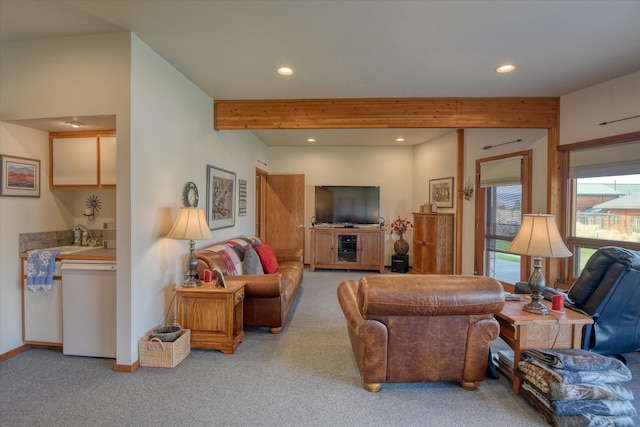 living room featuring beam ceiling and light colored carpet