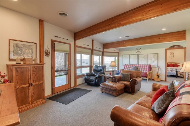 living room with beam ceiling and light carpet