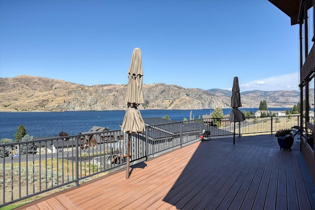 deck with a water and mountain view