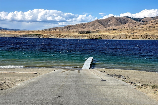 view of water feature featuring a beach view and a mountain view