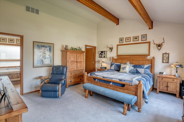 bedroom featuring lofted ceiling with beams, connected bathroom, and light colored carpet