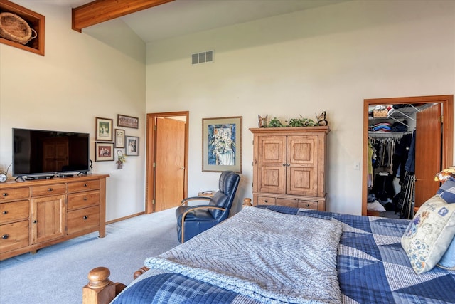 carpeted bedroom with lofted ceiling with beams, a spacious closet, and a closet