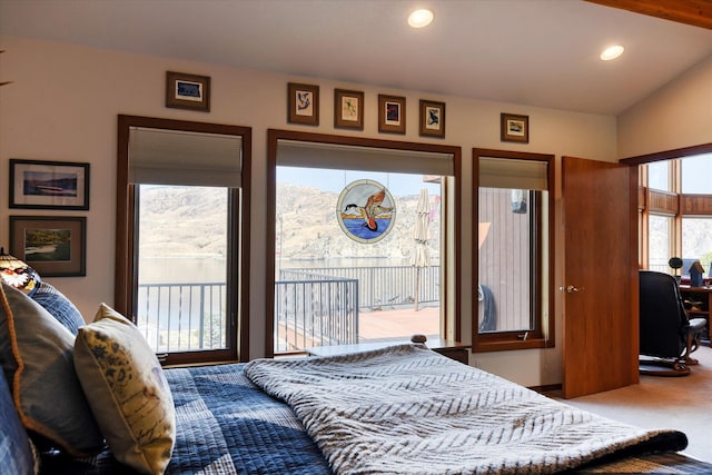 bedroom with vaulted ceiling, access to exterior, and carpet