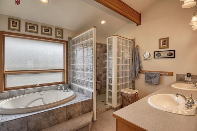 bathroom with lofted ceiling, shower with separate bathtub, and vanity