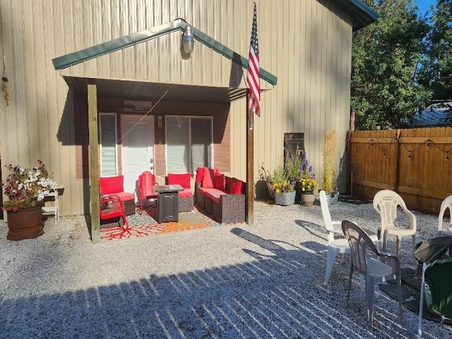 view of patio featuring an outdoor living space and fence