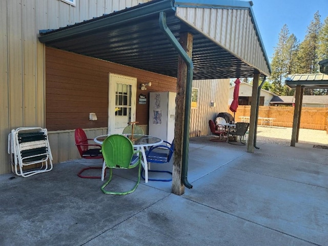 view of patio featuring fence and outdoor dining area