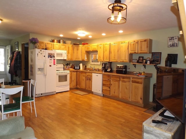 kitchen featuring a sink, recessed lighting, white appliances, and light wood-style flooring